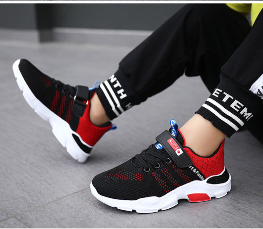 Boy's black and blue sports shoes with orange accents, mesh upper, white sole, blue laces, and a Velcro strap. - Image 18