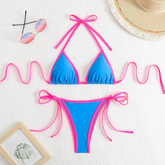 Royal blue two-piece bikini with light blue trim and tie straps, laid flat on a white textured surface. - Image 24