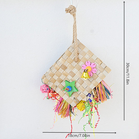 Colorful parrot foraging toy with woven palm leaf, a bell, wooden star, and shredded paper, hanging against a white wall. - Image 7