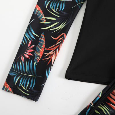 Women's long-sleeve tankini swimsuit with black top and blue tropical leaf print raglan sleeves, matching swim shorts. - Image 17