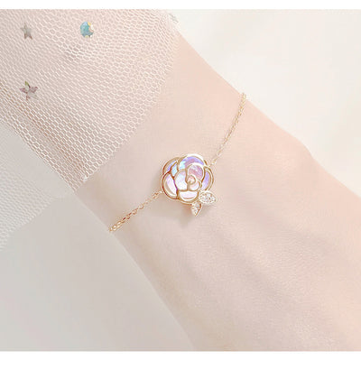Gold-tone necklace with an iridescent camellia flower pendant and small clear stones on a delicate chain. - Image 15
