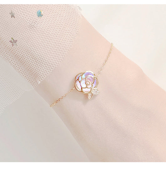 Gold-tone necklace with an iridescent camellia flower pendant and small clear stones on a delicate chain. - Image 15