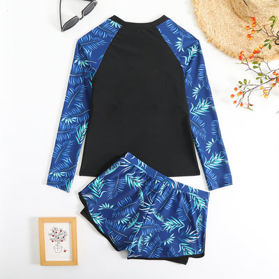 Women's long-sleeve tankini swimsuit with black top and blue tropical leaf print raglan sleeves, matching swim shorts. - Image 13