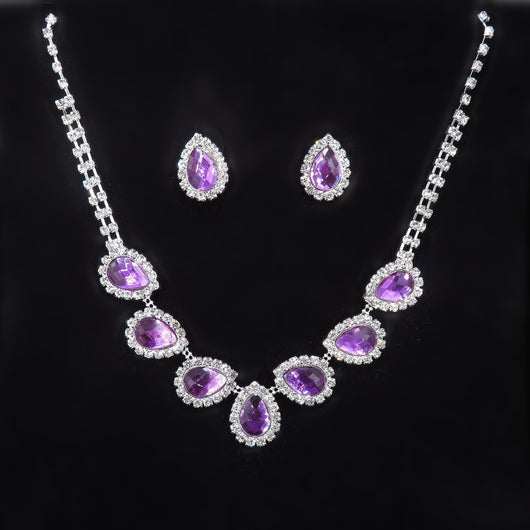 Purple teardrop rhinestone necklace and matching stud earrings set on a black background. - Image 16