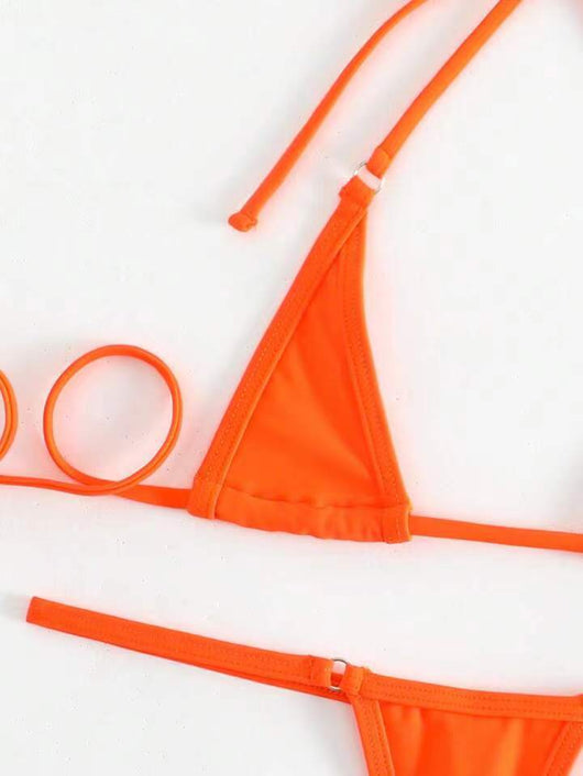 Orange solid color three-point bikini with a micro triangle top and thong bottom, modeled on a woman. - Image 25
