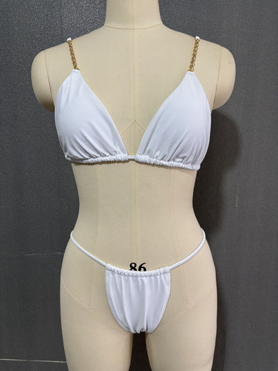 White three-point bikini with gold chain straps on a mannequin, featuring a triangle top and thong bottom. - Image 14