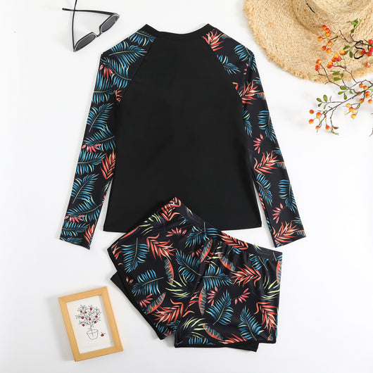 Women's long-sleeve tankini swimsuit with black top and blue tropical leaf print raglan sleeves, matching swim shorts. - Image 29