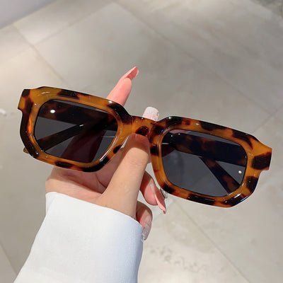 Black square-frame sunglasses with thick, angular frames and dark blue lenses, shown on a white background. - Image 26