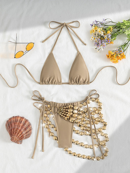 Copper halter bikini top and bottom with a gold beaded skirt, laid flat with sunglasses, seashell, and flowers. - Image 22