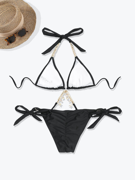 Olive green split bikini with gold chain and charm embellishments, worn with a sheer white cover-up on a beach. - Image 16