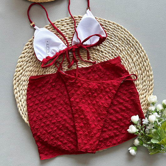 Red textured three-piece women's swimsuit set with triangle bikini top, thong bottom, and matching mini skirt. - Image 15