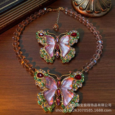 Pink enamel butterfly brooch with green, red, and clear rhinestones set in gold-toned metal. - Image 19
