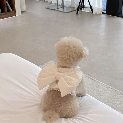 Creamy-white plush dog harness with a large decorative bow on the back, worn by a small poodle-like dog. - Image 12