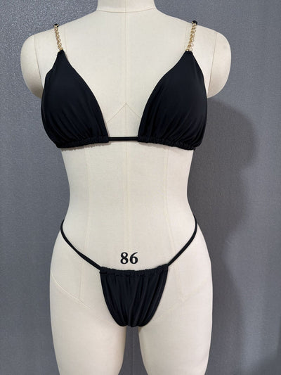 White three-point bikini with gold chain straps on a mannequin, featuring a triangle top and thong bottom. - Image 26