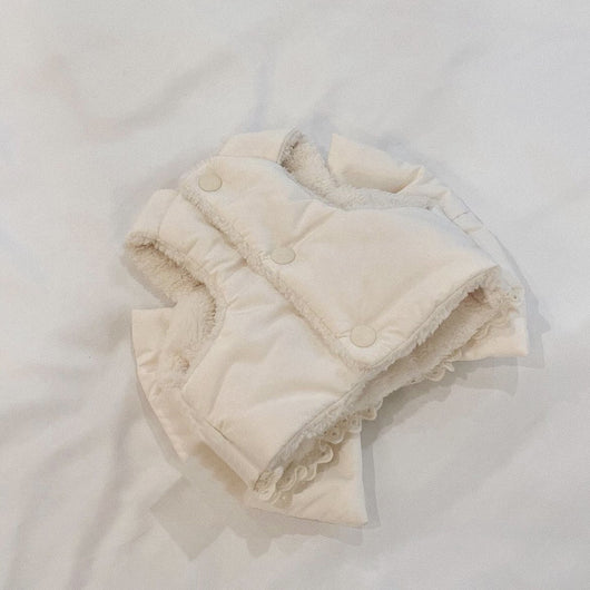 Creamy-white plush dog harness with a large decorative bow on the back, worn by a small poodle-like dog. - Image 10