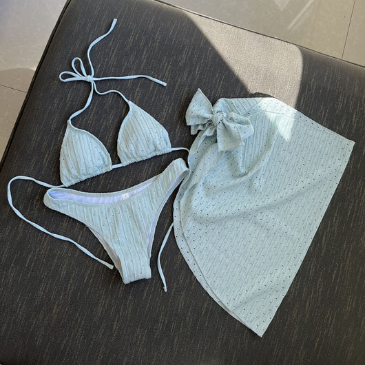 White textured bikini with ruched triangle top, high-cut bottom, and matching sarong with a large bow. - Image 31