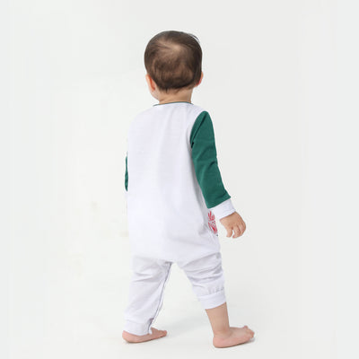 Woman in a Christmas pajama set with a white top, green sleeves, dinosaur graphic, and green fair isle pants. - Image 31