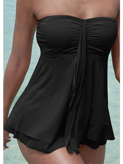 Woman in a brown strapless ruched one-piece swimdress with a flowing skirt, standing in shallow ocean water. - Image 15