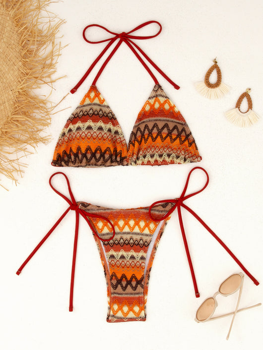 Black and white knitted zigzag bikini with triangle halter top and tie-side bottoms on a marble surface. - Image 16