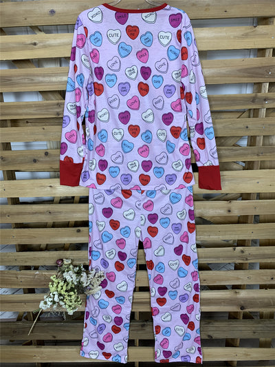 Pink long-sleeve pajama set with a conversation heart print, red Henley neckline, and matching full-length pants. - Image 18