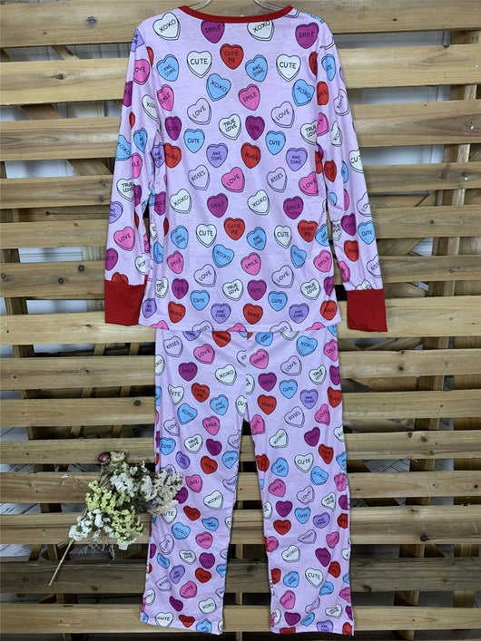 Pink long-sleeve pajama set with a conversation heart print, red Henley neckline, and matching full-length pants. - Image 18