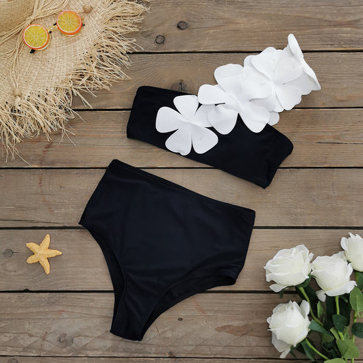 Women's black one-shoulder two-piece swimsuit with large white floral appliques and high-waisted bottoms. - Image 11