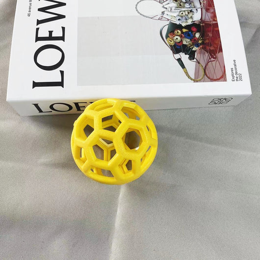 Orange TPR hollow lattice dog chew ball with a shiny pink bell ball inside for interactive pet play. - Image 4