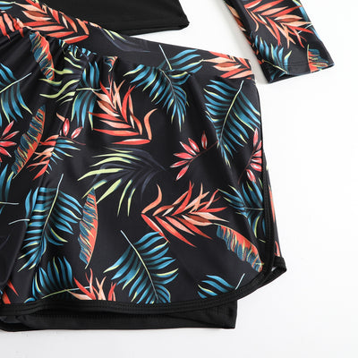 Women's long-sleeve tankini swimsuit with black top and blue tropical leaf print raglan sleeves, matching swim shorts. - Image 30