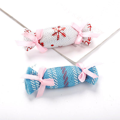 Six colorful fabric pet toys shaped like wrapped candies, featuring plaid, polka dot, and snowflake patterns. - Image 9