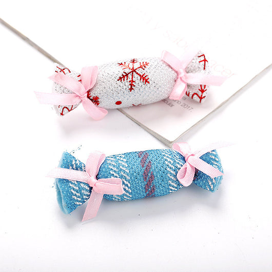 Six colorful fabric pet toys shaped like wrapped candies, featuring plaid, polka dot, and snowflake patterns. - Image 9