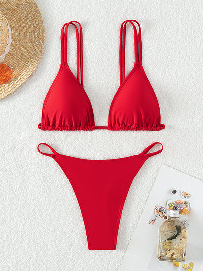 Red triangle cup halter bikini swimsuit for women on a sandy beach with ocean waves in the background. - Image 5