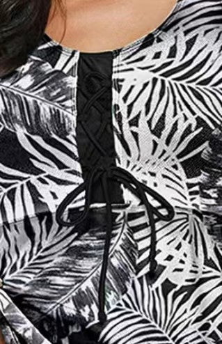 Women's black and white tropical leaf print tankini top with a black center panel and black swim bottoms. - Image 4