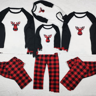 Matching family Christmas pajamas with white long-sleeve tops featuring a red plaid reindeer and red and black buffalo plaid pants.