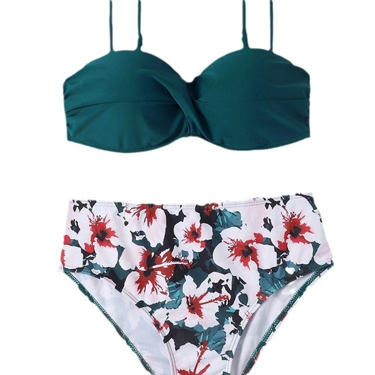 Teal twisted bandeau bikini top with tropical leaf print high-waisted bottoms on a model wearing a white shirt. - Image 4