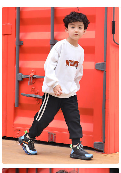 Black, white, and neon green children's basketball shoes with rotating buckle closure, featuring a mid-top design. - Image 21