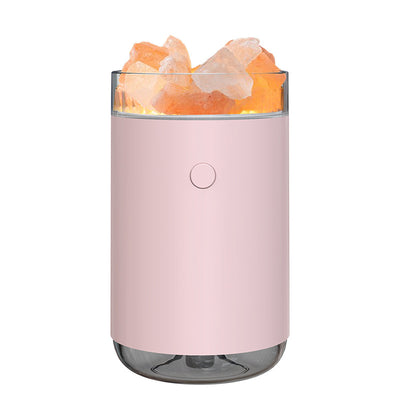 Pink cylindrical humidifier and essential oil diffuser with glowing orange crystal salt stones and a clear base. - Image 10