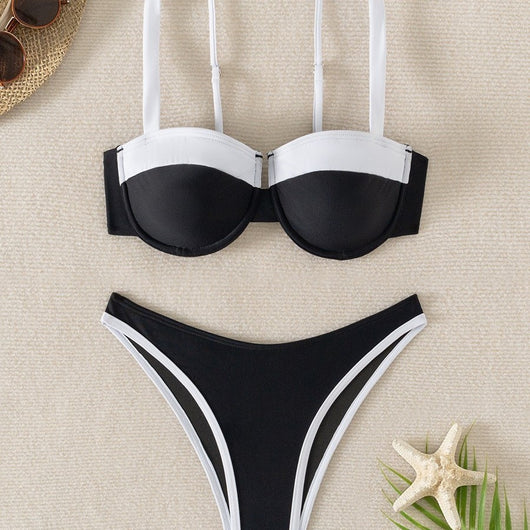 Black and white color block bikini with underwire top and high-cut bottoms, modeled by a woman by a pool. - Image 3