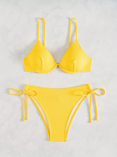 Black ribbed two-piece bikini with an underwire top and tie-side bottoms on a white marble surface. - Image 11