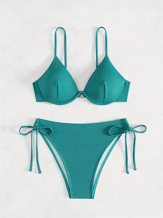Black ribbed two-piece bikini with an underwire top and tie-side bottoms on a white marble surface. - Image 10
