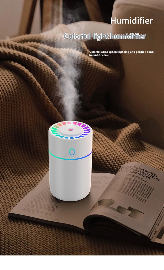 Pink cylindrical humidifier with a colorful LED light ring on top and a blue-green light band around its middle. - Image 8