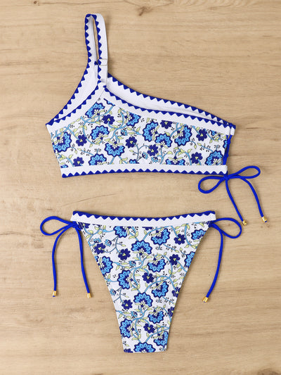 Women's one-shoulder bikini with red and blue floral print on white, featuring red trim and tie-side bottoms. - Image 19