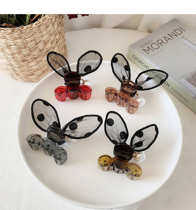 Black sheer polka dot rabbit ears hair claw clip with a faux pearl and gold-toned metal accents. - Image 18