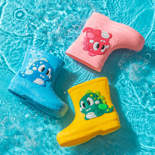 Bright yellow children's rain boots with a green cartoon dinosaur appliqué, designed for waterproof outdoor play. - Image 2