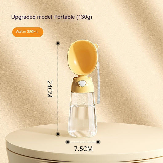 Yellow portable pet water bottle with clear reservoir, built-in drinking bowl, and wrist strap, 28cm tall. - Image 6