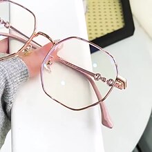 Rose gold frameless polygon anti-blue light glasses with clear lenses, held by a hand with pink nails. - Image 11