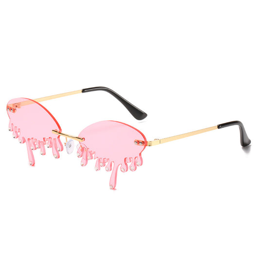 Rimless sunglasses with dark gray dripping liquid-shaped lenses, silver studs, and gold metal frames. - Image 8