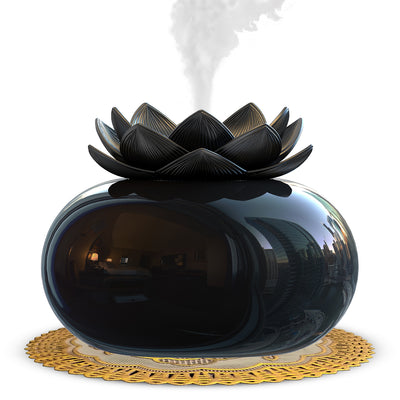 Black spherical aromatherapy humidifier with a lotus flower top, emitting mist, sitting on a gold decorative doily. - Image 3