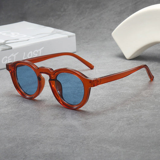 Vintage round frame sunglasses with black frames and pink lenses on a gray surface. - Image 15