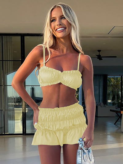 Fuchsia ruched tube top and matching pleated mini skirt set on a woman, perfect for summer. - Image 10