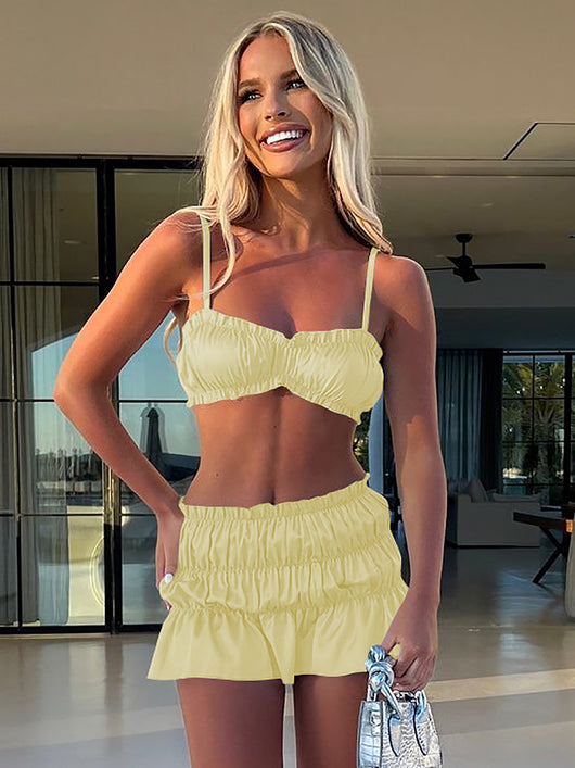 Fuchsia ruched tube top and matching pleated mini skirt set on a woman, perfect for summer. - Image 10